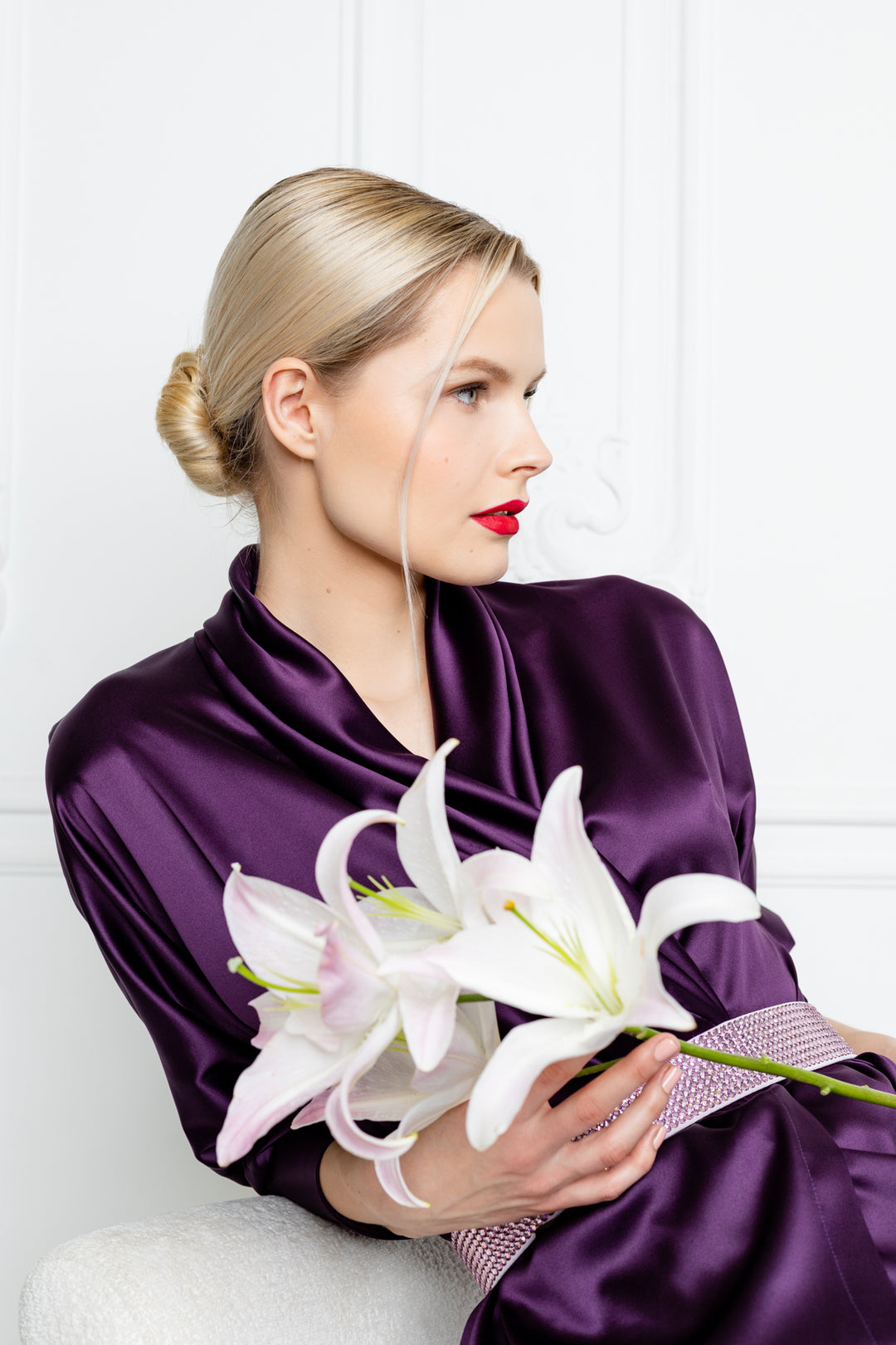 blonde woman is wearing a luxurious deep purple silk loungewear