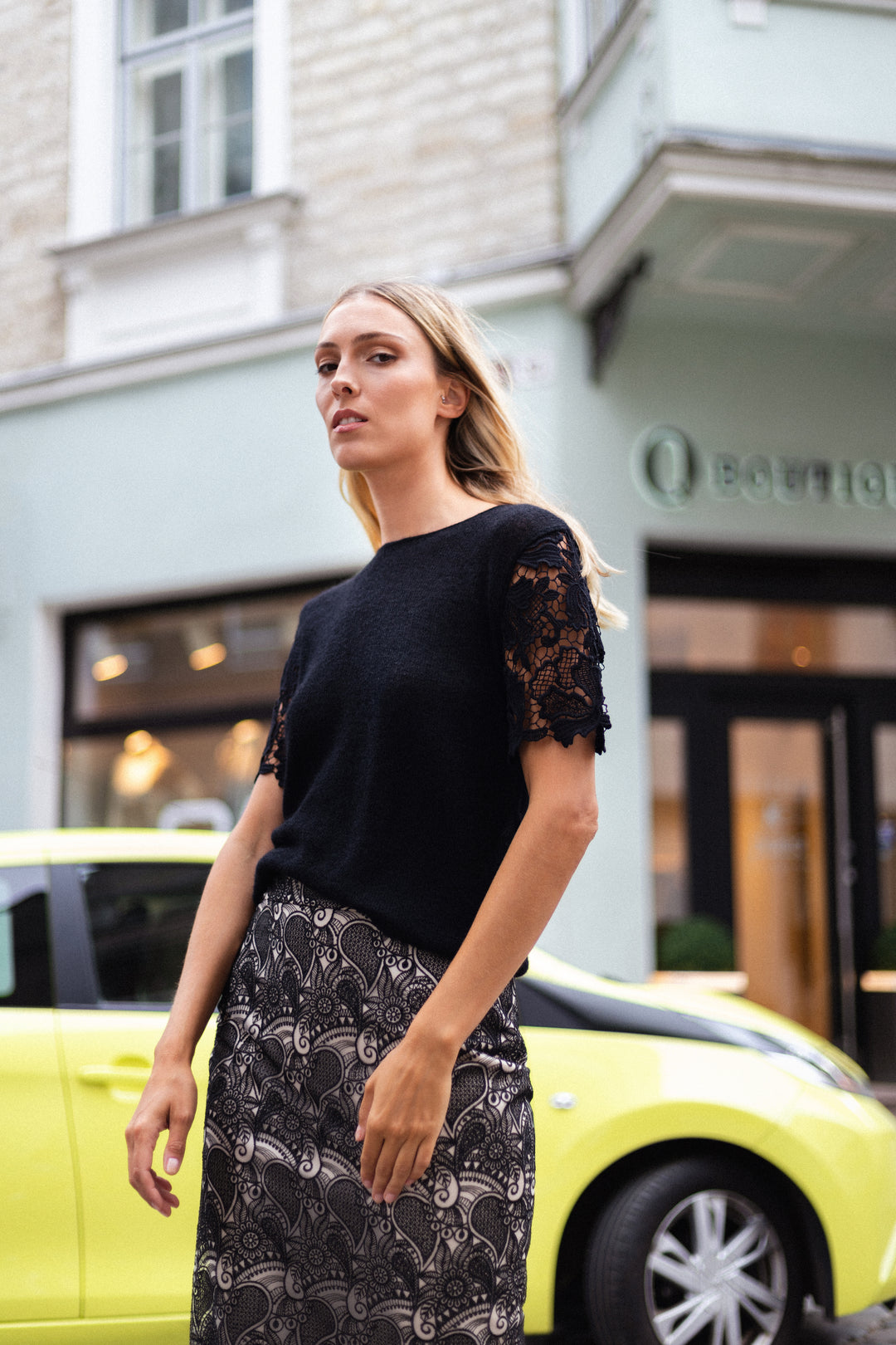 A Blond chic Woman is wearing Marimo's hit black lace Rubia skirt