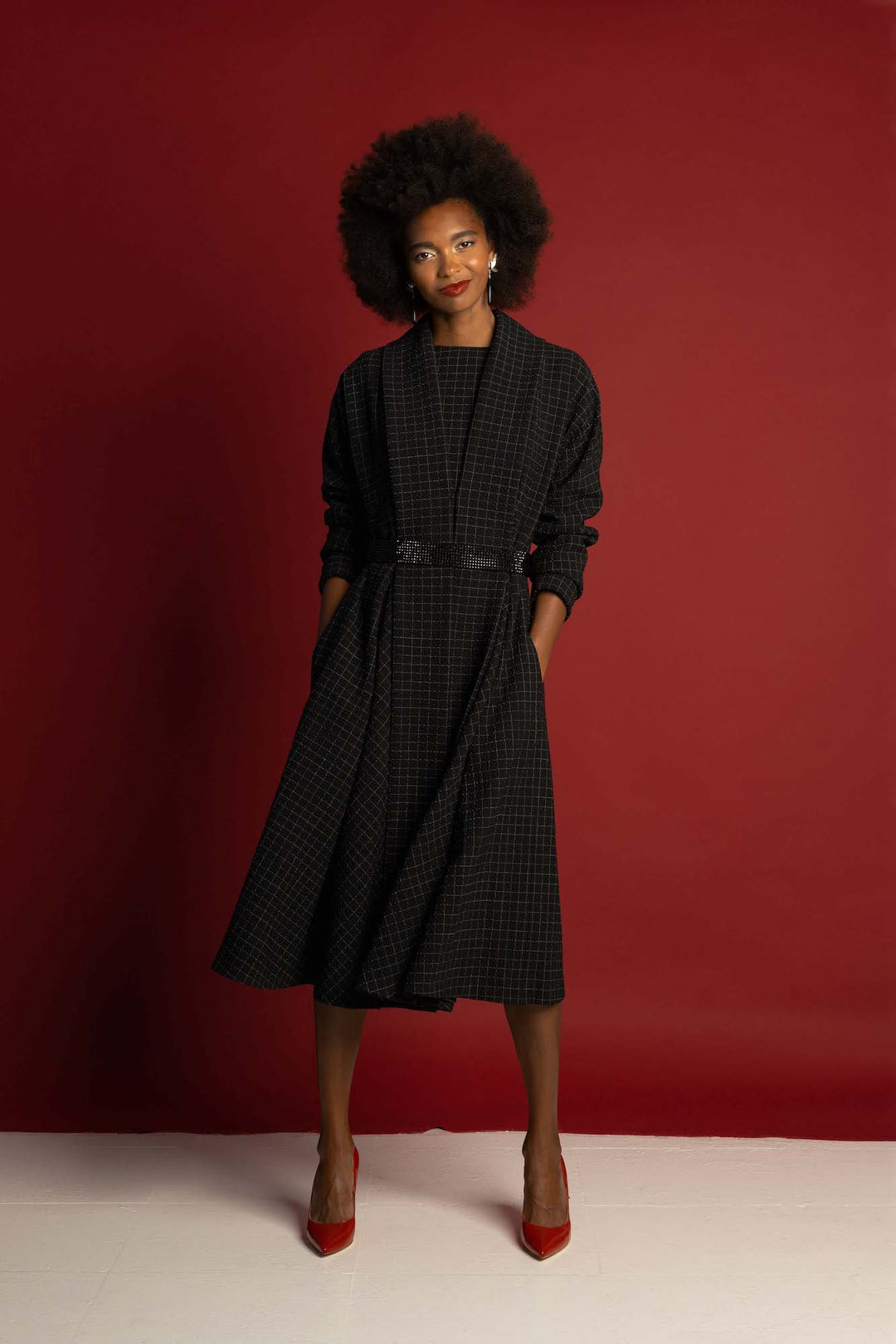 An elegant woman is wearing a plaid wool light-wear coat