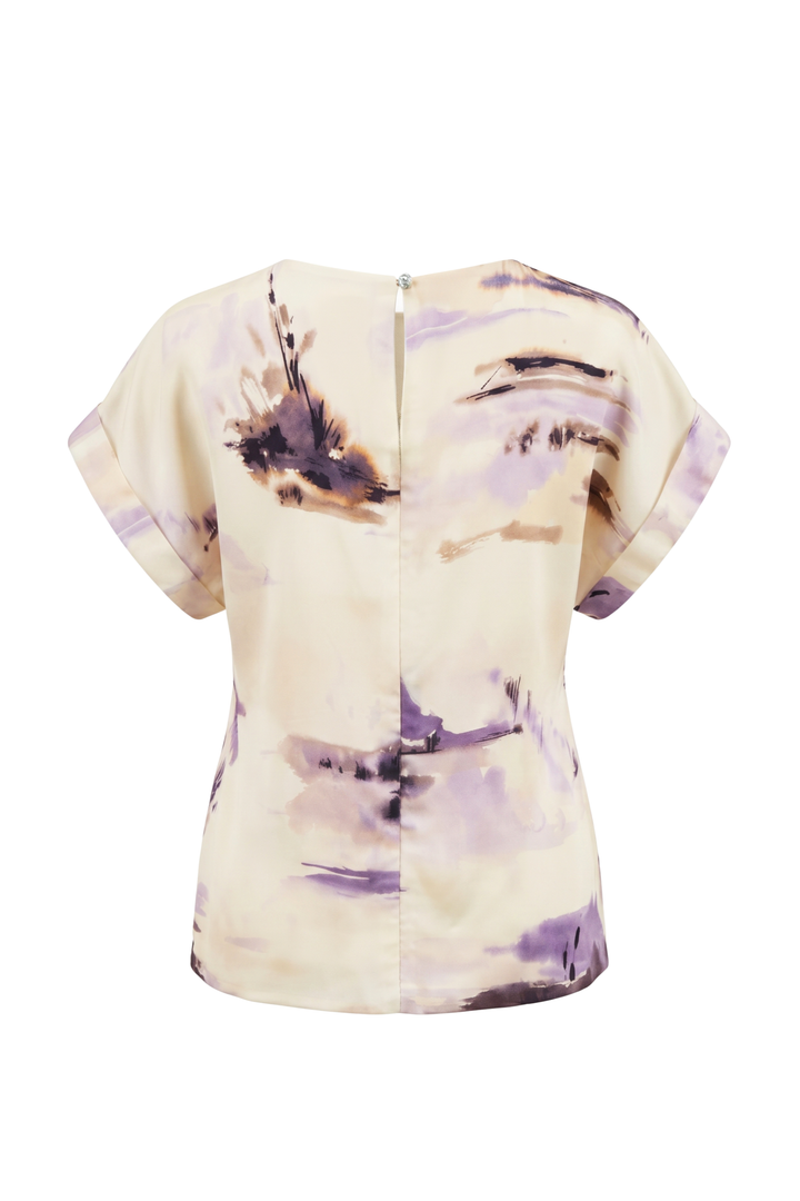 A short-sleeve top shown from the back, featuring an abstract watercolor-style print in purple, brown, and black on a cream-colored base.