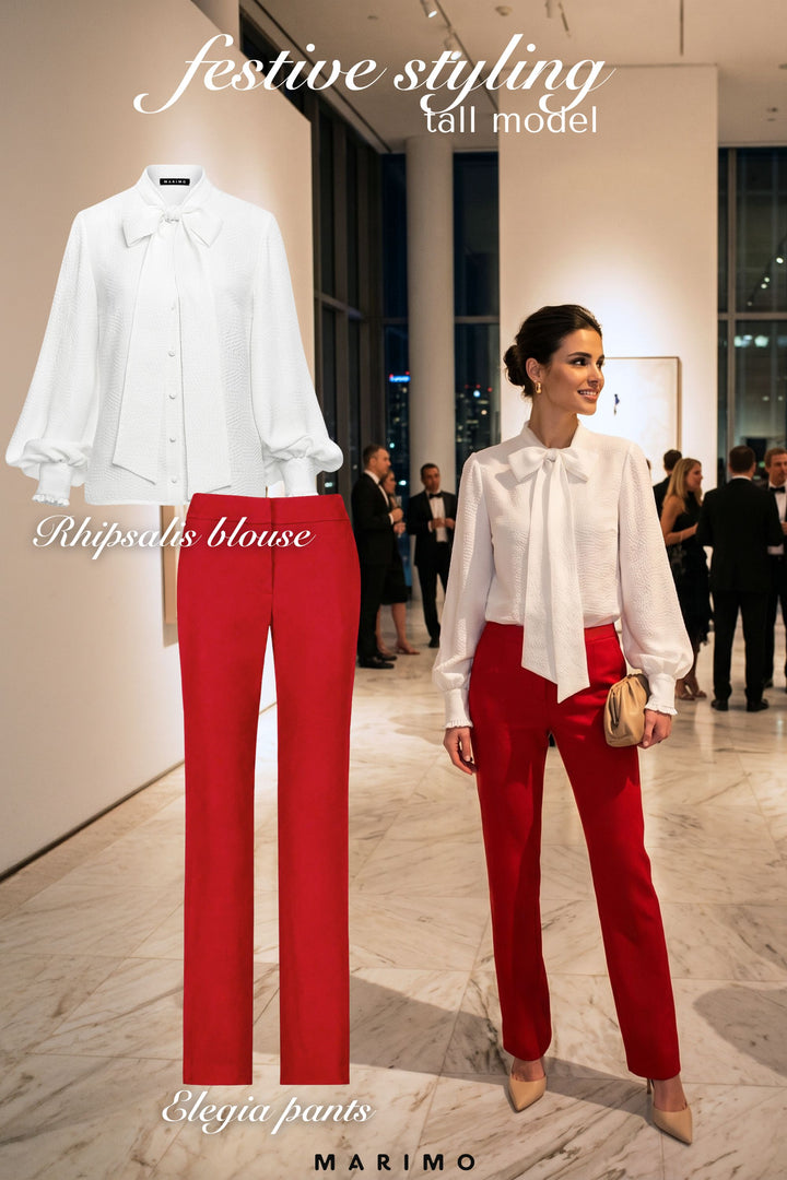 AI generated woman wearing a white neck-tie silk blouse and red tailored pants with a product photos displayed next to her in a festive setting.