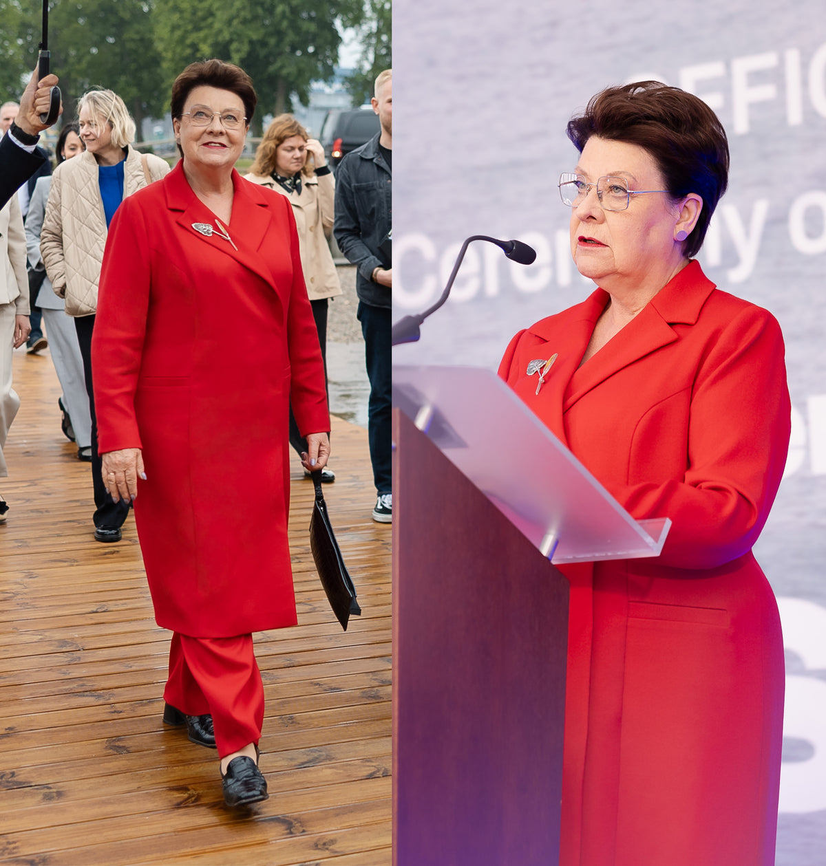 Woman in a red outfit walking and speaking at a podium.