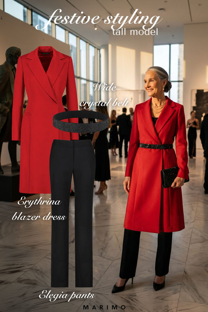 AI generated woman wearing a red tailored blazer dress and black tailored pants in a gallery setting with text overlay on festive styling.