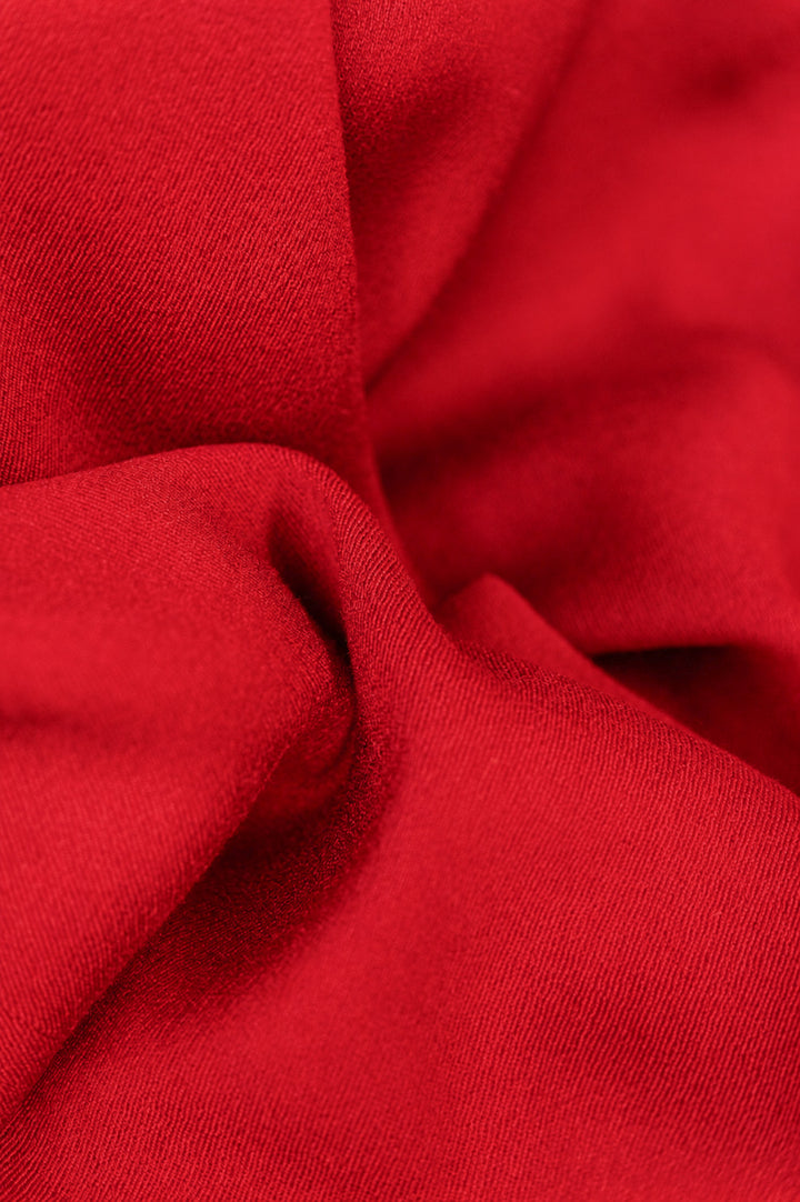 Close-up of red wool fabric with folds