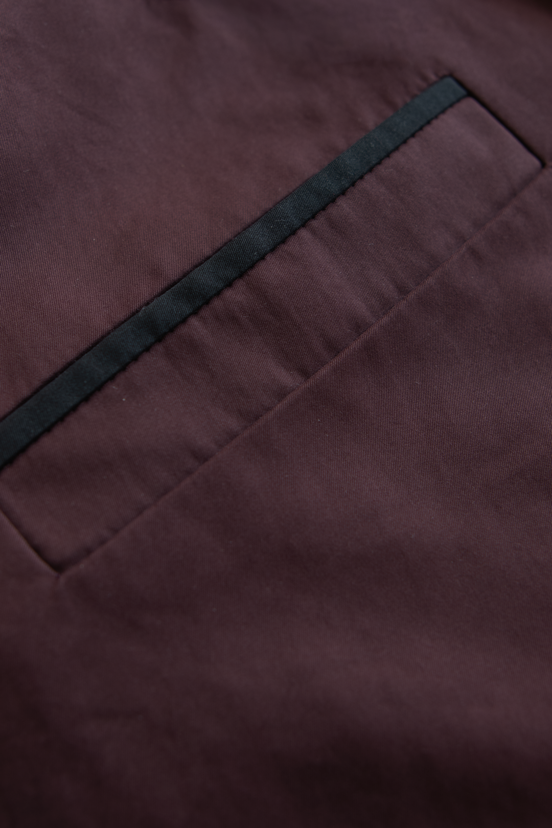 Front pocket detail on a luxury women's trench jacket.