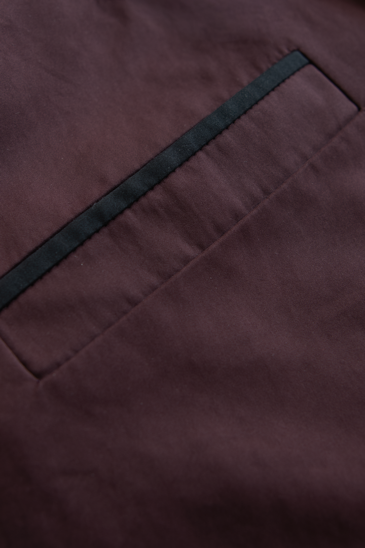 Front pocket detail on a luxury women's trench jacket.